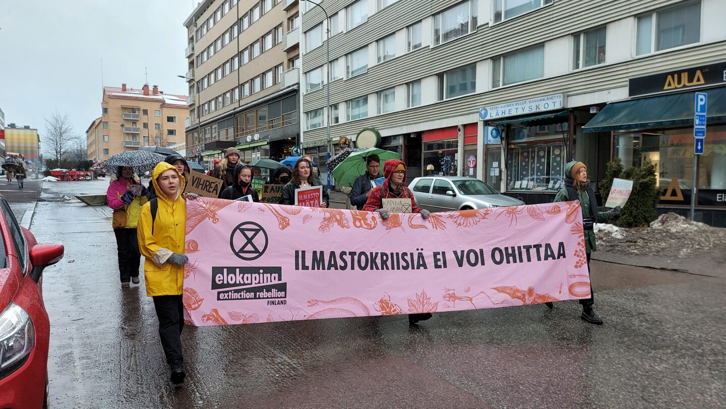 Mielenosoittajia marssimassa Kauppakatua kohti kompassia 25.3.2022 ilmastolakkotapahtumassa.