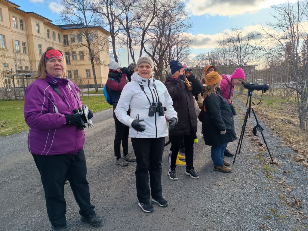 Ihmisiä kiikaroimassa linturetkellä